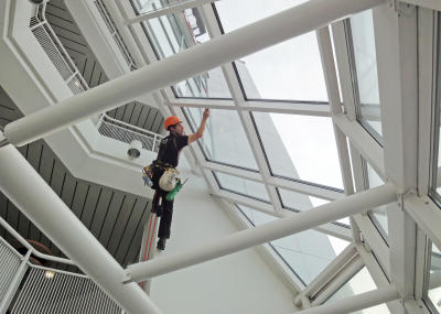 Industriekletterer bei Glasreinigung am hängenden Seil, Arbeit am Seil